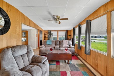 THIS CHARMING 2-bedroom, 2-bath mobile home is nestled in the on Bay Tree Golf Course in Florida - for sale on GolfHomes.com, golf home, golf lot