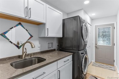 Nestled along a picturesque golf course and completely updated on Oak Pointe Country Club in Michigan - for sale on GolfHomes.com, golf home, golf lot