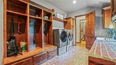 Welcome to a one-of-a-kind luxury estate in a gated Osage Beach on Sycamore Creek Golf Club in Missouri - for sale on GolfHomes.com, golf home, golf lot