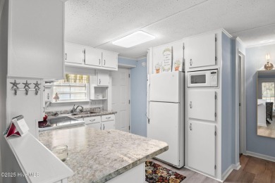 This charming residence is ideally located near the beach on Oyster Bay Golf Links in North Carolina - for sale on GolfHomes.com, golf home, golf lot