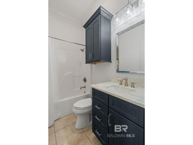 Discover coastal luxury in this former model home, meticulously on Peninsula Golf and Racquet Club in Alabama - for sale on GolfHomes.com, golf home, golf lot