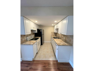 Bright first floor condo in Wynmoor, a gated 55 plus community on Wynmoor Golf Course in Florida - for sale on GolfHomes.com, golf home, golf lot