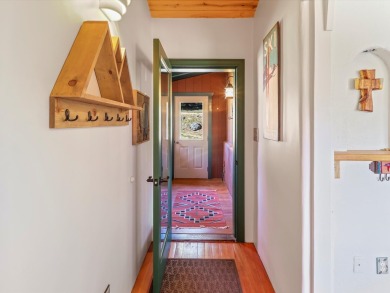 Welcome to The Great Escape, a desirable 3BR/2BA alpine home on El Valle Escondido Golf Course in New Mexico - for sale on GolfHomes.com, golf home, golf lot