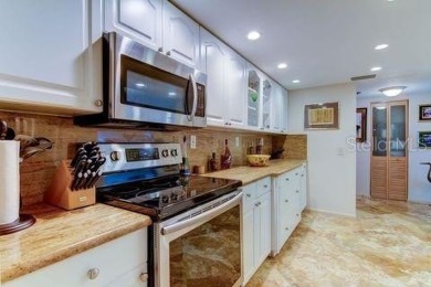 Embrace the epitome of Coastal Living on the 8th floor of this on Isla Del Sol Yacht and Country Club in Florida - for sale on GolfHomes.com, golf home, golf lot