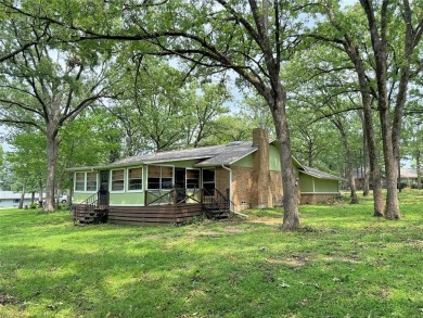 This charming water front home sits on a spacious tract under a on Star Harbor Golf Club in Texas - for sale on GolfHomes.com, golf home, golf lot