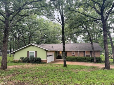 This charming water front home sits on a spacious tract under a on Star Harbor Golf Club in Texas - for sale on GolfHomes.com, golf home, golf lot