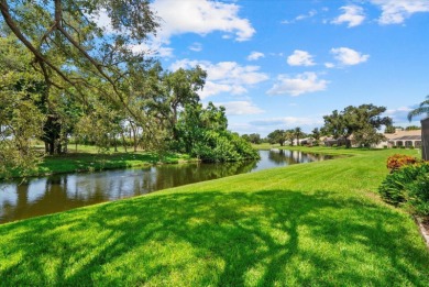 Enjoy stunning lake and golf course views framed by mature trees on Waterford Golf Club in Florida - for sale on GolfHomes.com, golf home, golf lot