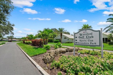 Enjoy stunning lake and golf course views framed by mature trees on Waterford Golf Club in Florida - for sale on GolfHomes.com, golf home, golf lot