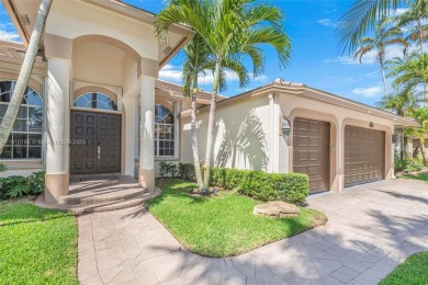 Luxury living awaits in this stunning one-story pool home on the on Weston Hills Country Club in Florida - for sale on GolfHomes.com, golf home, golf lot