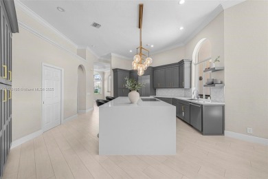 Luxury living awaits in this stunning one-story pool home on the on Weston Hills Country Club in Florida - for sale on GolfHomes.com, golf home, golf lot