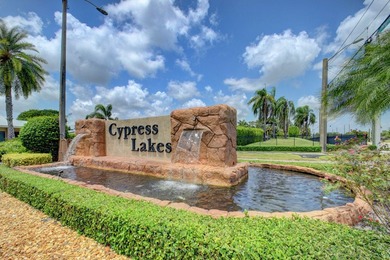 Beautiful one-story villa located in a desirable 24-hour manned on Cypress Lakes Golf Course - West Palm Beach in Florida - for sale on GolfHomes.com, golf home, golf lot