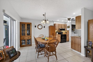 Beautiful one-story villa located in a desirable 24-hour manned on Cypress Lakes Golf Course - West Palm Beach in Florida - for sale on GolfHomes.com, golf home, golf lot