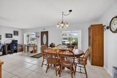 Beautiful one-story villa located in a desirable 24-hour manned on Cypress Lakes Golf Course - West Palm Beach in Florida - for sale on GolfHomes.com, golf home, golf lot