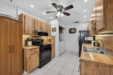 Beautiful one-story villa located in a desirable 24-hour manned on Cypress Lakes Golf Course - West Palm Beach in Florida - for sale on GolfHomes.com, golf home, golf lot