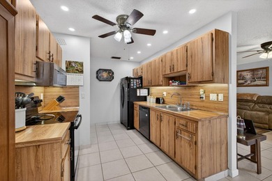 Beautiful one-story villa located in a desirable 24-hour manned on Cypress Lakes Golf Course - West Palm Beach in Florida - for sale on GolfHomes.com, golf home, golf lot