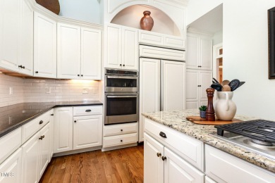 Experience luxury living where waterfront serenity meets golf on Country Club of Johnston County in North Carolina - for sale on GolfHomes.com, golf home, golf lot