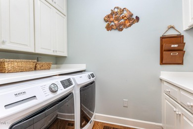 Experience luxury living where waterfront serenity meets golf on Country Club of Johnston County in North Carolina - for sale on GolfHomes.com, golf home, golf lot