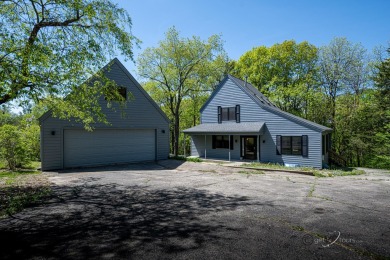 This Branigar farmhouse-style home is set on a beautiful, wooded on Eagle Ridge Inn and Resort in Illinois - for sale on GolfHomes.com, golf home, golf lot