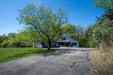 This Branigar farmhouse-style home is set on a beautiful, wooded on Eagle Ridge Inn and Resort in Illinois - for sale on GolfHomes.com, golf home, golf lot