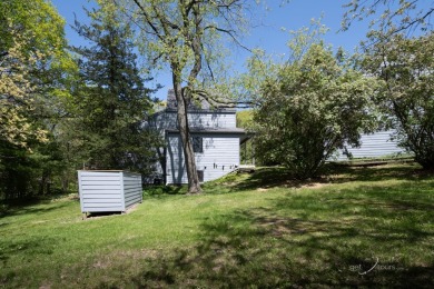 This Branigar farmhouse-style home is set on a beautiful, wooded on Eagle Ridge Inn and Resort in Illinois - for sale on GolfHomes.com, golf home, golf lot