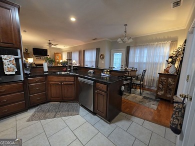 Welcome to this beautifully maintained all-brick home, ideally on Canongate At Georgia National Golf Club in Georgia - for sale on GolfHomes.com, golf home, golf lot