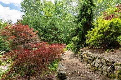 This one-of-a-kind, beautifully maintained four-bedroom on Lake Toxaway Country Club in North Carolina - for sale on GolfHomes.com, golf home, golf lot