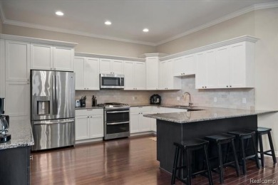 Enjoy maintenance-free golf course living on the first green of on Pine Knob Golf Club - Hawk in Michigan - for sale on GolfHomes.com, golf home, golf lot