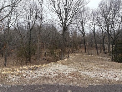 Tucked among mature trees on a rare double corner lot on Linn Valley Lakes - Deer Trace Golf Course in Kansas - for sale on GolfHomes.com, golf home, golf lot