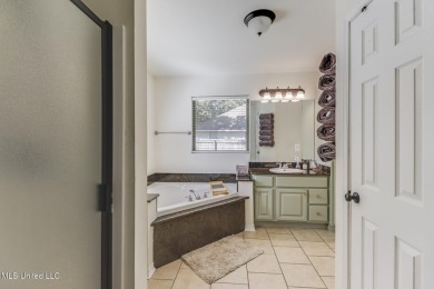 Located in the heart of Diamondhead, this 3-bedroom, 2-bath home on Diamondhead Country Club in Mississippi - for sale on GolfHomes.com, golf home, golf lot