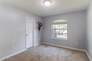 Located in the heart of Diamondhead, this 3-bedroom, 2-bath home on Diamondhead Country Club in Mississippi - for sale on GolfHomes.com, golf home, golf lot