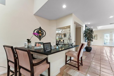 Enjoy golf and water views from this charming one-story on Delray Dunes Golf and Country Club in Florida - for sale on GolfHomes.com, golf home, golf lot