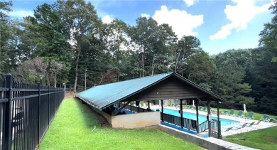 Nestled atop a gentle hill and surrounded by graceful Hemlocks on White Path Golf Club in Georgia - for sale on GolfHomes.com, golf home, golf lot