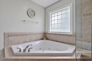 Enjoy serene pond views with this stunning brick home located in on Cape Fear National At Brunswick Forest in North Carolina - for sale on GolfHomes.com, golf home, golf lot