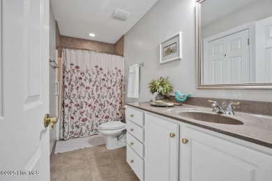 Enjoy serene pond views with this stunning brick home located in on Cape Fear National At Brunswick Forest in North Carolina - for sale on GolfHomes.com, golf home, golf lot