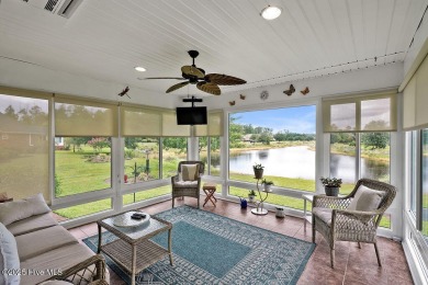 Enjoy serene pond views with this stunning brick home located in on Cape Fear National At Brunswick Forest in North Carolina - for sale on GolfHomes.com, golf home, golf lot
