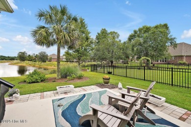 Enjoy serene pond views with this stunning brick home located in on Cape Fear National At Brunswick Forest in North Carolina - for sale on GolfHomes.com, golf home, golf lot
