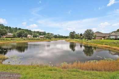 Enjoy serene pond views with this stunning brick home located in on Cape Fear National At Brunswick Forest in North Carolina - for sale on GolfHomes.com, golf home, golf lot