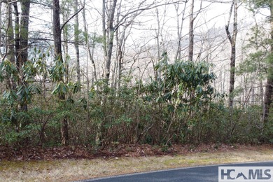 This prime building site offers potential mountain views of the on Sapphire National Golf Club in North Carolina - for sale on GolfHomes.com, golf home, golf lot
