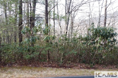 This prime building site offers potential mountain views of the on Sapphire National Golf Club in North Carolina - for sale on GolfHomes.com, golf home, golf lot