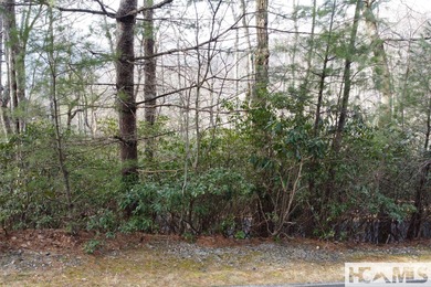 This prime building site offers potential mountain views of the on Sapphire National Golf Club in North Carolina - for sale on GolfHomes.com, golf home, golf lot