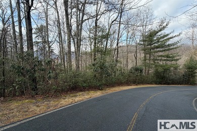 This prime building site offers potential mountain views of the on Sapphire National Golf Club in North Carolina - for sale on GolfHomes.com, golf home, golf lot