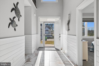 The welcoming covered entry of 33418 Islander Drive invites you on The Peninsula Golf and Country Club in Delaware - for sale on GolfHomes.com, golf home, golf lot