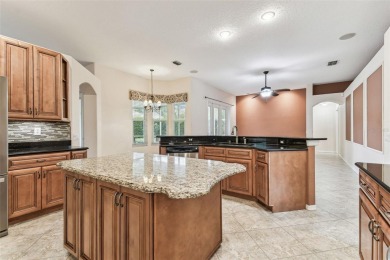 Location, Location - Tampa Palms beauty. This 4/3/2 plus a den on Tampa Palms Golf and Country Club in Florida - for sale on GolfHomes.com, golf home, golf lot