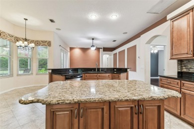 Location, Location - Tampa Palms beauty. This 4/3/2 plus a den on Tampa Palms Golf and Country Club in Florida - for sale on GolfHomes.com, golf home, golf lot
