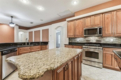 Location, Location - Tampa Palms beauty. This 4/3/2 plus a den on Tampa Palms Golf and Country Club in Florida - for sale on GolfHomes.com, golf home, golf lot