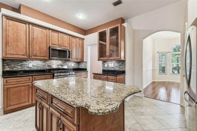 Location, Location - Tampa Palms beauty. This 4/3/2 plus a den on Tampa Palms Golf and Country Club in Florida - for sale on GolfHomes.com, golf home, golf lot
