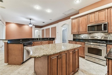 Location, Location - Tampa Palms beauty. This 4/3/2 plus a den on Tampa Palms Golf and Country Club in Florida - for sale on GolfHomes.com, golf home, golf lot