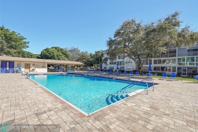 55+Step into the lap of luxury with this stunning Property in on Wynmoor Golf Course in Florida - for sale on GolfHomes.com, golf home, golf lot