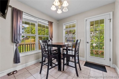 Step onto the covered porch to soak in the peaceful surroundings on Carolina Lakes Country Club in North Carolina - for sale on GolfHomes.com, golf home, golf lot