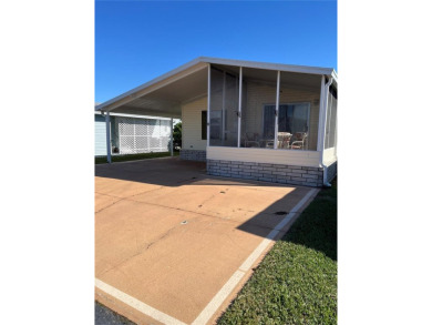 This house is nestled in the sleepy town of Frostproof located on Lily Lake Golf and RV Resort in Florida - for sale on GolfHomes.com, golf home, golf lot